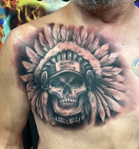 a tattoo of an indian skull on a man's chest