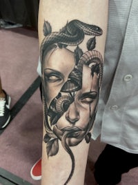 a tattoo of a woman with a snake on her arm